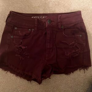 Distressed maroon AE jean shorts